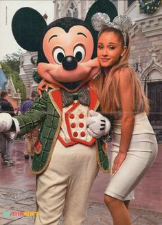 two women pose with mickey mouse in front of the castle at disney's magic kingdom