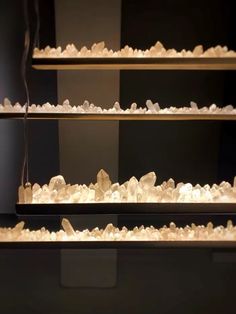 three shelves filled with white rocks on top of each other