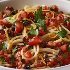 a white bowl filled with pasta and vegetables