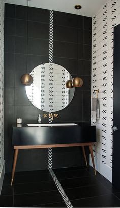 a black and white bathroom with a mirror