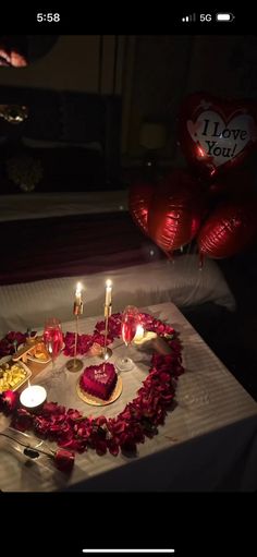 a heart shaped cake with candles on it