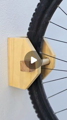 a close up of a bike tire on a wall with a video showing how to use it