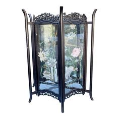 an ornately decorated glass display case with flowers on the front and side panels,