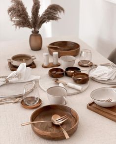 the table is set with dishes and silverware