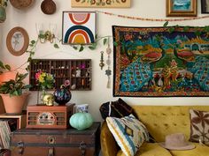 a living room filled with furniture and pictures on the wall