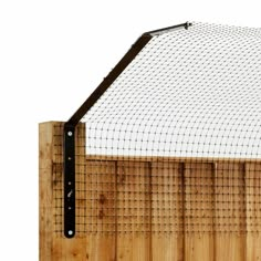 a close up of a wooden fence with a net on the top and bottom half