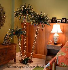 a bedroom decorated with christmas lights and palm trees