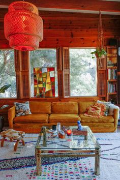 a living room filled with furniture and lots of windows