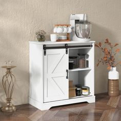 a white cabinet with an open door on the top and shelves below it, in front of a beige wall