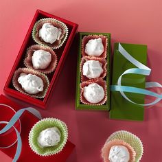 three small boxes filled with cupcakes on top of a table