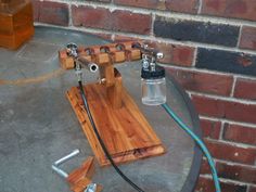 a wooden device is sitting on top of a table with some wires attached to it