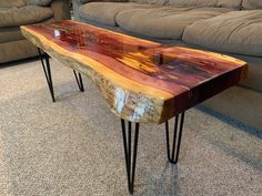 a wooden table with hairpin legs on carpeted floor next to couches in living room