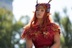 a woman dressed as a fairy with horns and leaves on her head