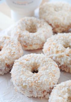 coconut donuts are sitting on a paper towel