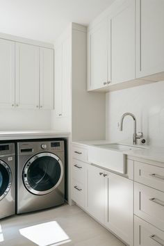 a washer and dryer in a white kitchen