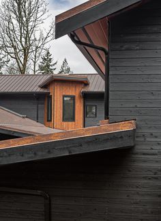 the roof of a house that has a wooden shingled structure on it's side