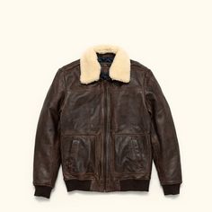 A leather jacket as rugged and iconic as the battle-tested captains of the sky. Where classic aviator style meets first-class quality and design. Crafted with 100% genuine lambskin leather, our brown leather bomber jacket features a zip closure, ribbed cuffs and waist, and a detachable sherpa collar to provide extra warmth and comfort for brisk nights on the town or chasing the horizon. On the outside, right away you’ll notice the buttery soft lambskin leather. From day one, it has that vintage, Aviator Leather Jacket, Heavy Clothing, Belt Top, Aviator Style, Leather Trench Coat, Suits Coats, Lambskin Leather, The Sky, Brown Leather