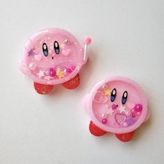 two pink toys with hearts and stars on them