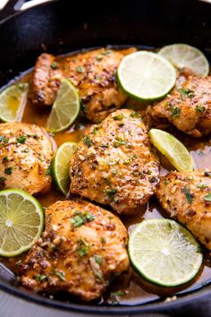 chicken with limes and spices in a skillet ready to be served for dinner