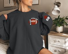 Custom Football Sweatshirt, Football Mom Sweatshirt, Sports Mom Hoodie, Custom Football Mom Sweatshirt with Kid Name,Football Season Sweater We're here to give you the best sweatshirt and hoodie options for you. We want to make everyone smile with our cute, stylish and trendy graphic sweatshirts and hoodies. We can assured you this sweatshirt or hoodie will be perfect gift whether you will buy it yourself or for someone else. PLEASE ATTENTİON We use black design for Sport grey, white and sand; w Collegiate Black Sweatshirt For Football Season, Fall Sports Team Sweatshirt, Casual Black Sweatshirt For Football Season, Black Football Season Sweatshirt, Long Sleeve Sportswear Sweatshirt For Fans, Sportswear Long Sleeve Sweatshirt For Fans, Sports Fan Long Sleeve Hoodie, Long Sleeve Tops For Sports Events, Black Sports Fan Sweatshirt