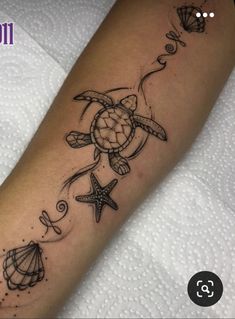 a turtle and starfish tattoo on the arm