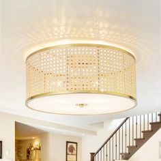 a living room filled with lots of furniture and a chandelier hanging from the ceiling