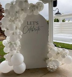 an arch made out of balloons with the words let's celebrate written on it