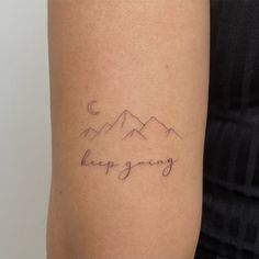 a woman with a tattoo on her arm that says, happy spring in the mountains