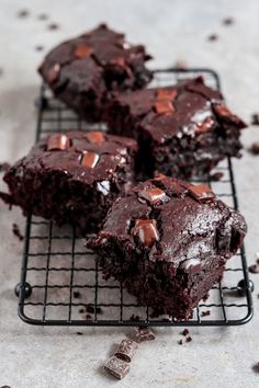 chocolate brownies on a cooling rack with one cut in half