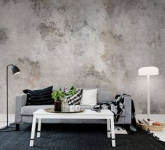 a living room with a couch, coffee table and large world map on the wall