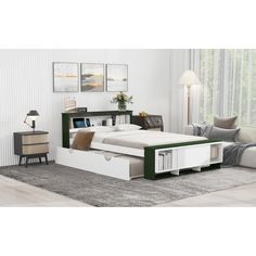 a white bed with green trim and drawers in a room next to a gray rug