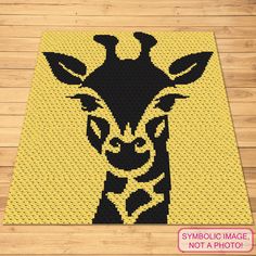 a black and yellow giraffe is shown on a wooden floor with the words symbol image not a photo