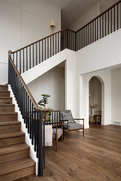 the stairs in this house are made of wood and have black railings on them