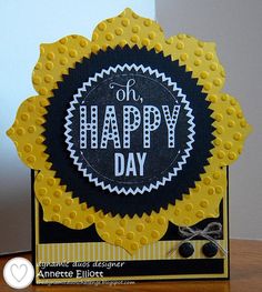 a yellow and black happy day card on a table