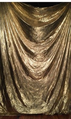 an image of a gold curtain with words on it