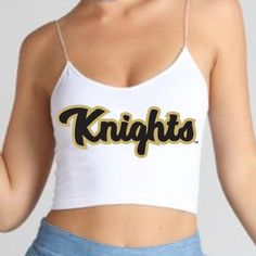 This super flattering UCF Knights White Spaghetti Tank Top is perfect for college game day paired with our UCF Game Day Skirt! In stock & ships in 1-2 business days. One Size Fits Most. 88% Micropoly, 12% Spandex. Stretchy & soft fabric designed for all day use & long lasting quality. Sublimated Design. Machine wash on cold. Officially Licensed by Lo + Jo Bands. Fitted Casual Tank Top For Sports Events, Fitted Seamless Tops For Sportswear, Seamless Fitted Tops For Sports Season, Casual Fitted Tank Top For Sports Events, Sports Fitted Spaghetti Strap Crop Top, Sports Spaghetti Straps Fitted Crop Top, Fitted Spaghetti Strap Sports Crop Top, Casual Spaghetti Strap Sports Top, College Game Day