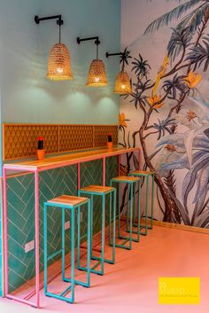 a colorful bar with three stools next to it