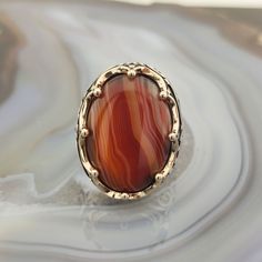 The ring is made of 925 sterling silver and adorned with Striped agate stone. PRODUCT FEATURES -Products are shipped with free shipping with box and bag. - Crafting Material : 925K Sterling Silver - Weight : 18.0 grams - Gemstone Diameter : 18 x 25 mm - Gemstone :Striped agate - Gender : Male / Female ✔ Ready to Ship in 1-3 Business Days ✔ Shipped to the worldwide 1-3 business days with free express shipping. ✔ The product will be sent to you with a box to avoid any damage during shipping. Diges Polished Agate Oval Cabochon Rings, Oval Cabochon Agate Ring With Polished Finish, Agate Gemstone Rings In Oval Cabochon Shape, Agate Gemstone Rings In Oval Cabochon, Oval Agate Signet Ring With Polished Finish, Oval Agate Ring With Large Stone, Oval Agate Rings With Polished Finish, Oval Agate Hallmarked Rings, Oval Brown Agate Rings