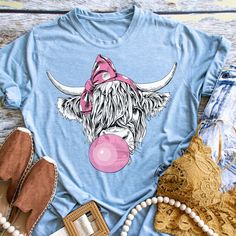 You will love this adorable bubble gum cow tee. Not only is it cute but it super comfy. Made with on a popular Bella Canvas tee you will not be disappointed  in the quality of this shirt.  All of our items are made with love in our home in the USA.  We are located in Oak Ridge, TN. We ship directly to you.  About Our Clothing. All of our shirts are unisex, unless it is noted in the description. We try to have size and color charts on all product listings. Sometimes they do get left out during the listing process. If you need help with your sizing options please message us.  Care Instructions: This shirt is done with a screen printed transfer and applied with our commercial heat press. Because of the nature of this print it is strongly recommended to wash cold and hang to dry.  Our processi Cow Shirts, Cute Shirts For Women, Heifer Shirt, Shirt Display, Cow Shirt, Cute Cow, Bella Canvas Tees, Cute Cows, Highland Cow