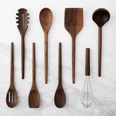 wooden utensils lined up on a marble surface