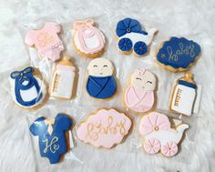 baby shower cookies in plastic wrapper on white furnishing with blue and pink decorations