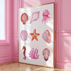 a pink room with sea shells and starfish on the wall