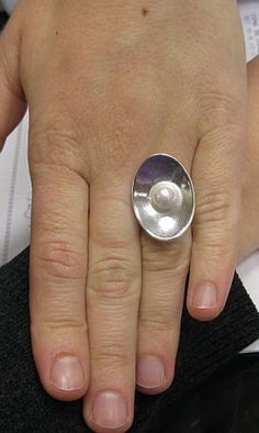 Sterling silver ring 925/1000. Ellipse with 8mm round synthetic pearl. Adjustable size.Stamped 925.Approximate weight 11.5 grams. Front dimensions 2.9x2.0cm. All our jewels are made from solid sterling silver 925/1000 and are carefully crafted by hand in our family workshop. We dispatch your orders in 5 working days, worldwide and the postage is $5. We ship registered priority mail. Please allow 5-7 working days for delivery in Europe and 10-15 working days outside Europe. For any questions - pl Hallmarked Oval Pearl Ring In Sterling Silver, Hallmarked Sterling Silver Oval Pearl Ring, Oval Sterling Silver Hallmarked Pearl Ring, Sterling Silver Pearl Ring Stamped 925, Modern Silver Pearl Ring, Formal Round Pearl Ring Stamped 925, Ring With Pearl, Sterling Silver Ring, Priority Mail