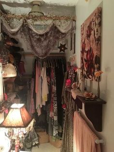 the closet is filled with clothes and other items