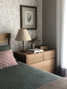 a bed room with a neatly made bed and a lamp