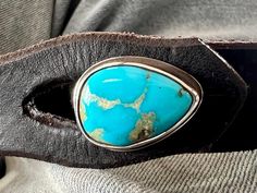 This is natural Nevada rare Montezuma Turquoise   cabochon from the Otteson's mine, Sterling Silver Button, on a  Distressed leather band with a  Sterling  Silver Button, on and Distressed Leather Bracelet.  size 8"  All leather bands can be traded out for a different size. Unique Adjustable Turquoise Teardrop Ring, Unique Adjustable Teardrop Turquoise Ring, Adjustable Artisan Turquoise Ring With Concho, Adjustable Concho Turquoise Ring Gift, Adjustable Turquoise Concho Ring As Gift, Adjustable Turquoise Concho Ring For Gift, Montezuma, Silver Button, Royston Turquoise