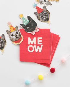 some red napkins that have pictures of cats on them and the words meow