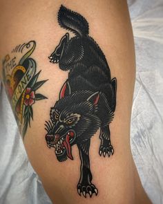 a black bear tattoo on the thigh