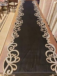 a long table covered in black velvet with gold sequins on the top and sides