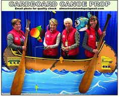 four women in red vests are standing on a boat with paddles and fish